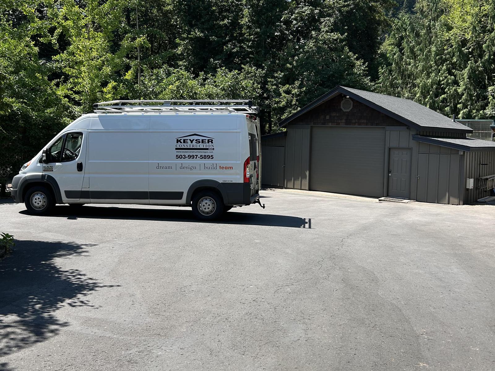 Keyser Construction work van with company name and phone number